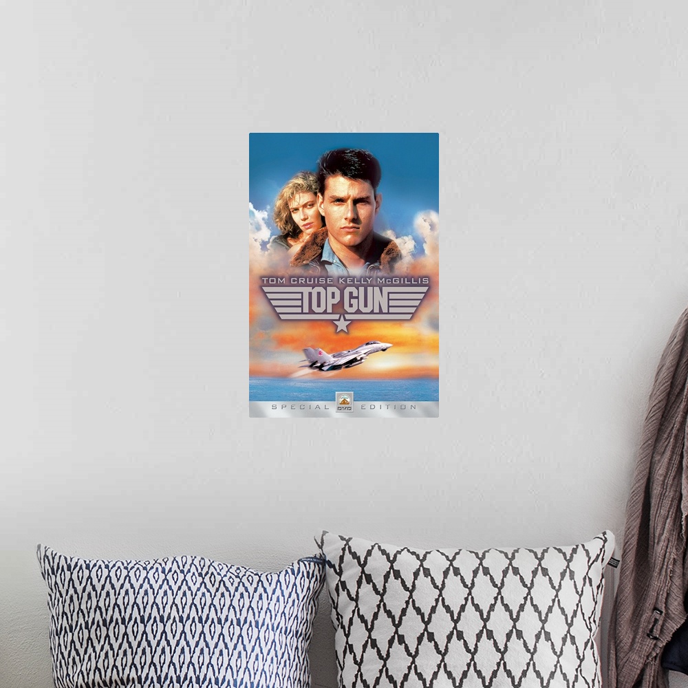 A bohemian room featuring Movie poster for Top Gun with Tom Cruise and Kelly McGillis in the sky as a military plane takes ...