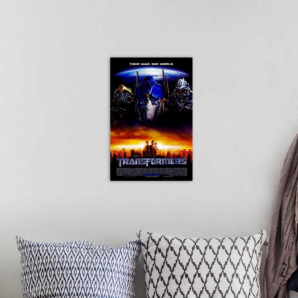 A bohemian room featuring Movie poster for the first Transformers film with the three main auto bots pictured above the cit...