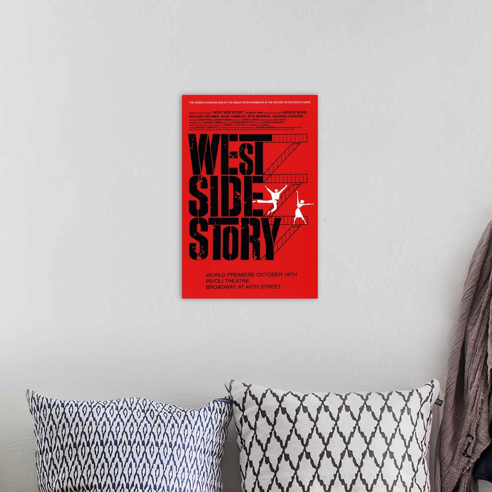 A bohemian room featuring Broadway poster for the popular show "West Side Story". Flights of stairs go up the right side of...
