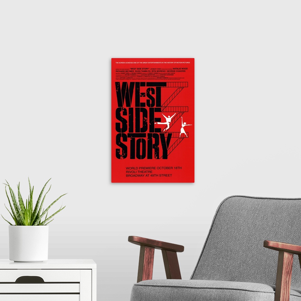 A modern room featuring Broadway poster for the popular show "West Side Story". Flights of stairs go up the right side of...