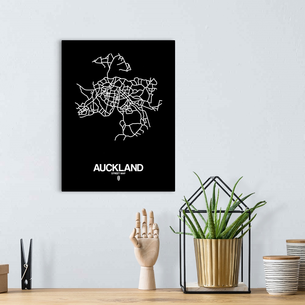 A bohemian room featuring Minimalist art map of the city streets of Auckland in black and white.