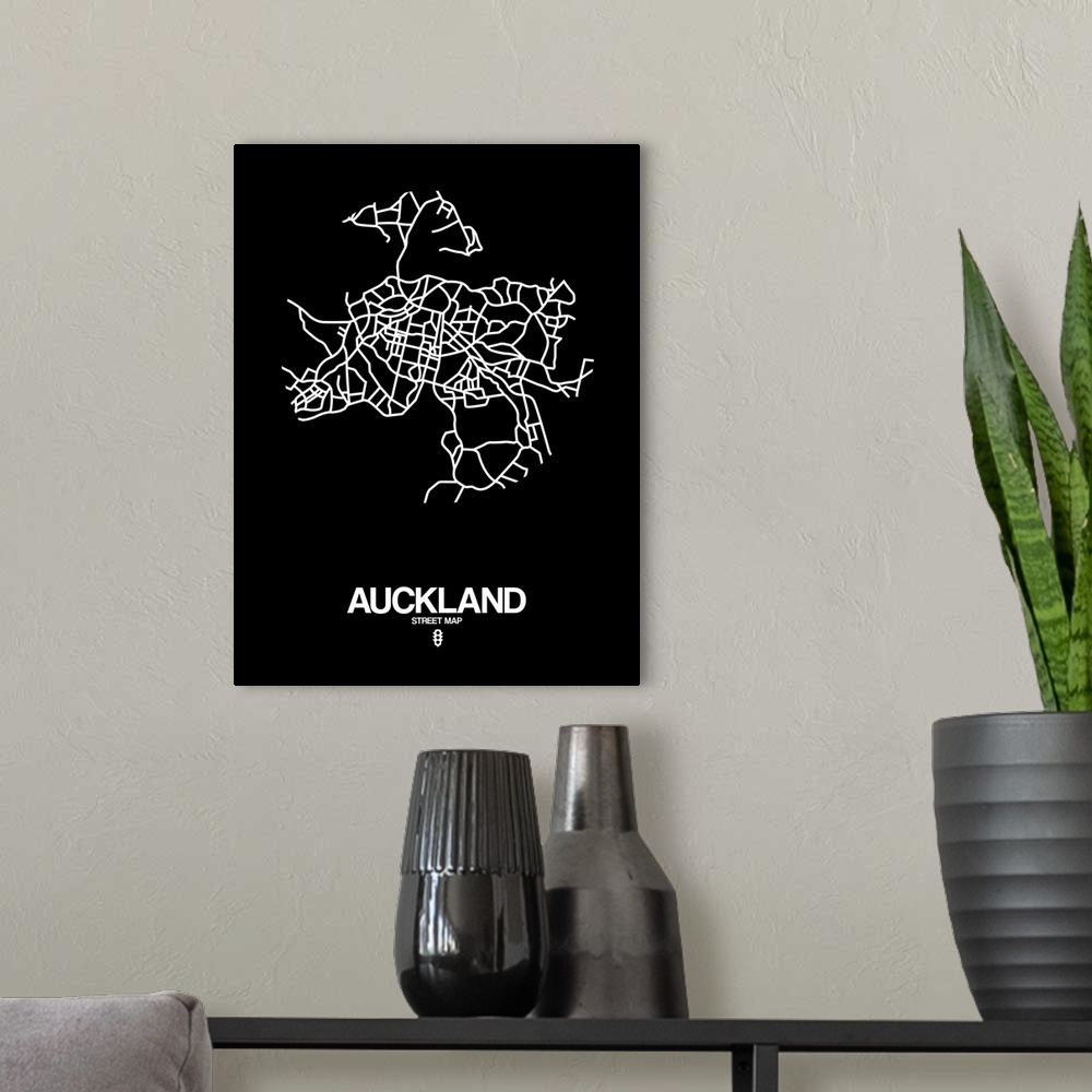 A modern room featuring Minimalist art map of the city streets of Auckland in black and white.