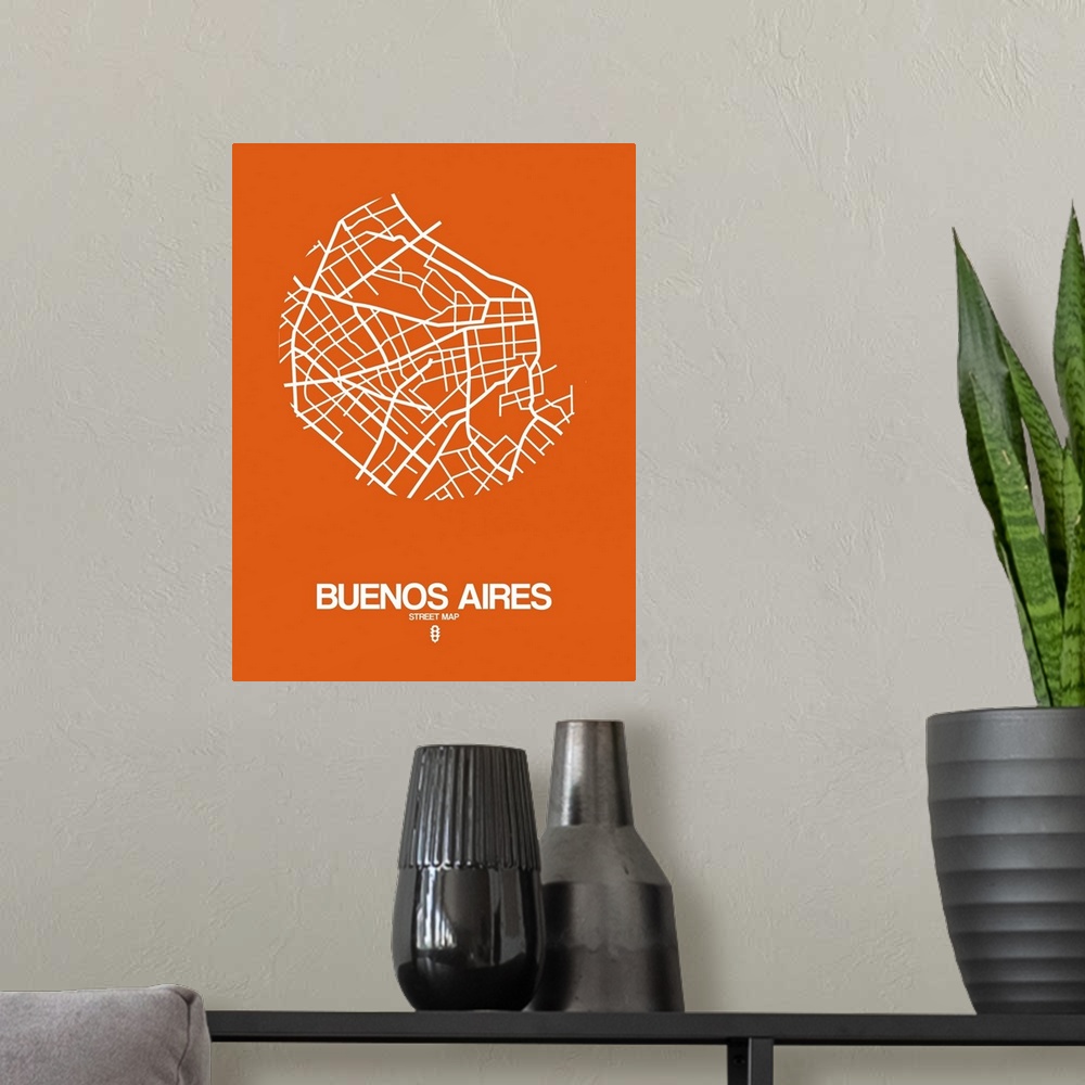 A modern room featuring Minimalist art map of the city streets of Buenos Aires in orange and white.