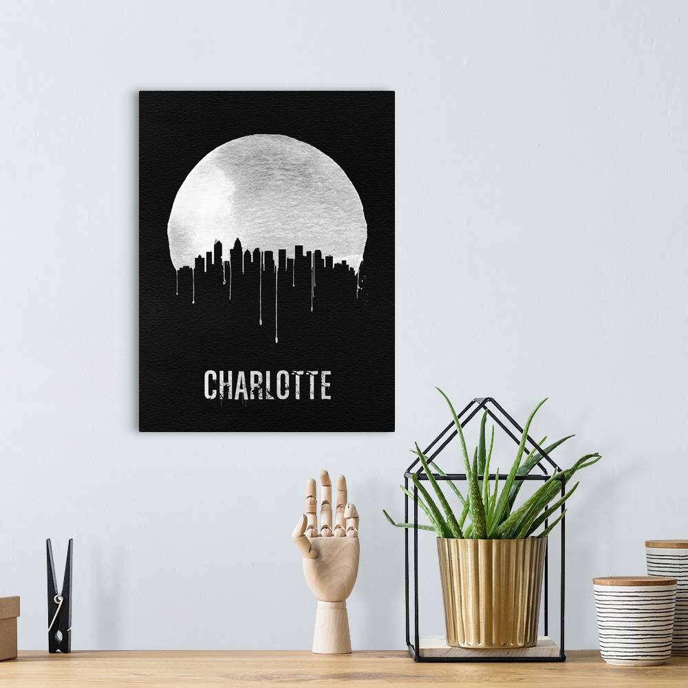 A bohemian room featuring Contemporary watercolor artwork of the Charlotte city skyline, in silhouette.