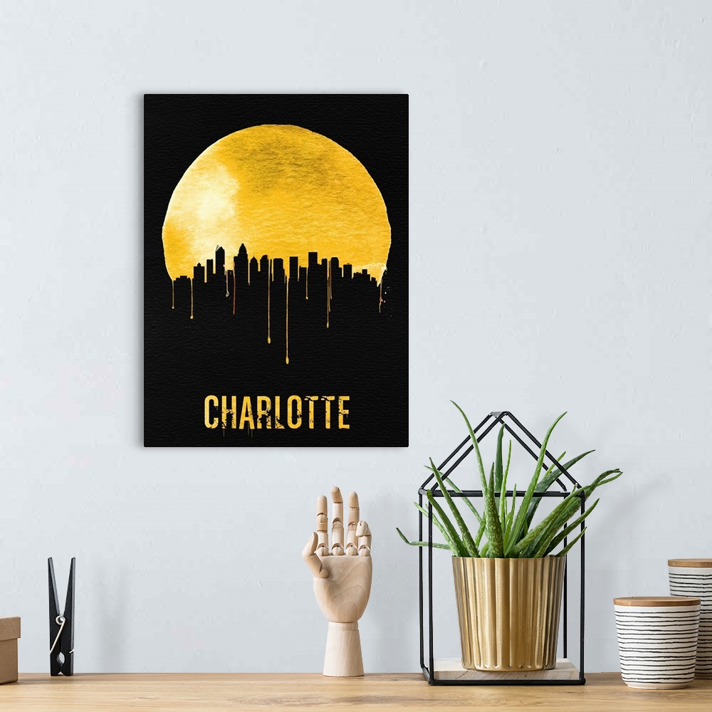 A bohemian room featuring Contemporary watercolor artwork of the Charlotte city skyline, in silhouette.