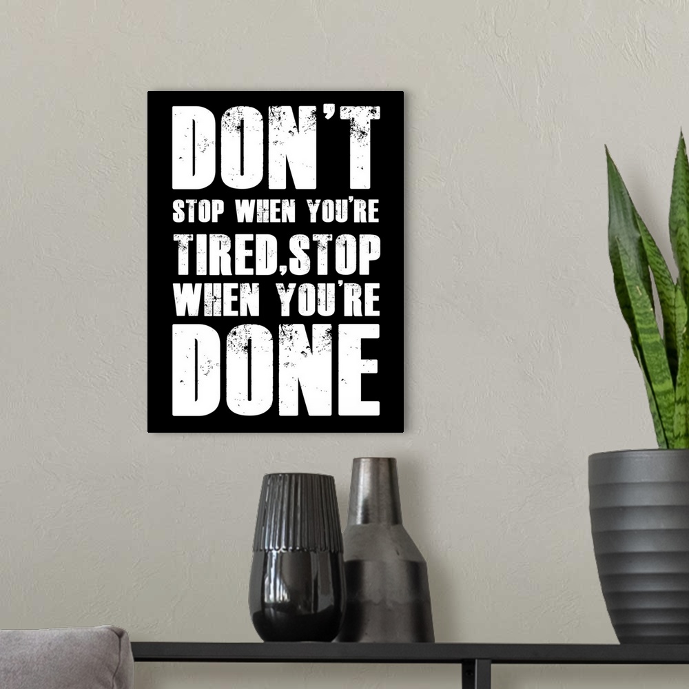 A modern room featuring A bold, masculine motivational quote on a black background. Perfect for home gym or recreation room
