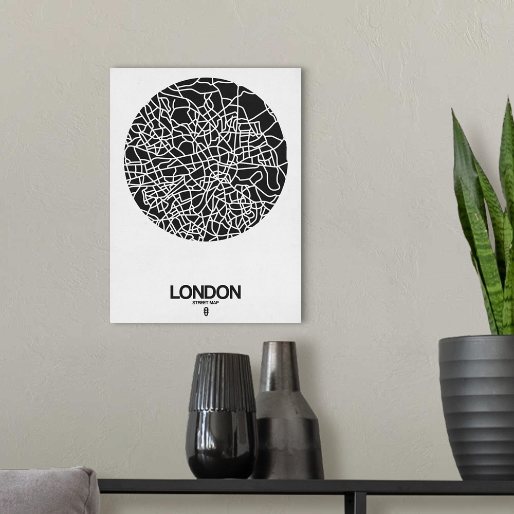 A modern room featuring Minimalist art map of the city streets of London in white and black.