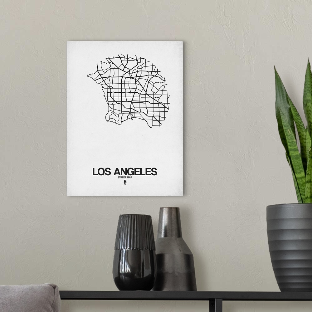 A modern room featuring Minimalist art map of the city streets of Los Angeles in white and black.