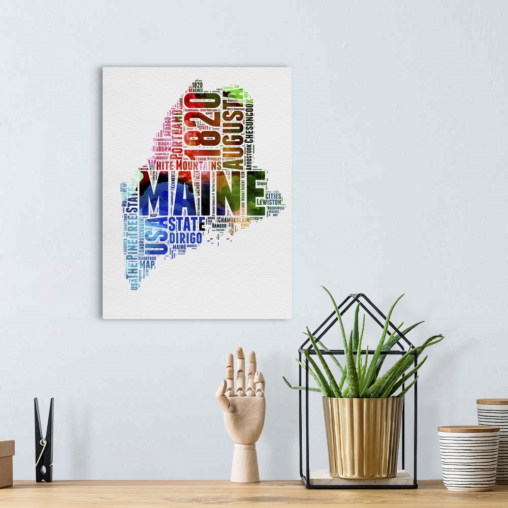 A bohemian room featuring Watercolor typography art map of the US state Maine.