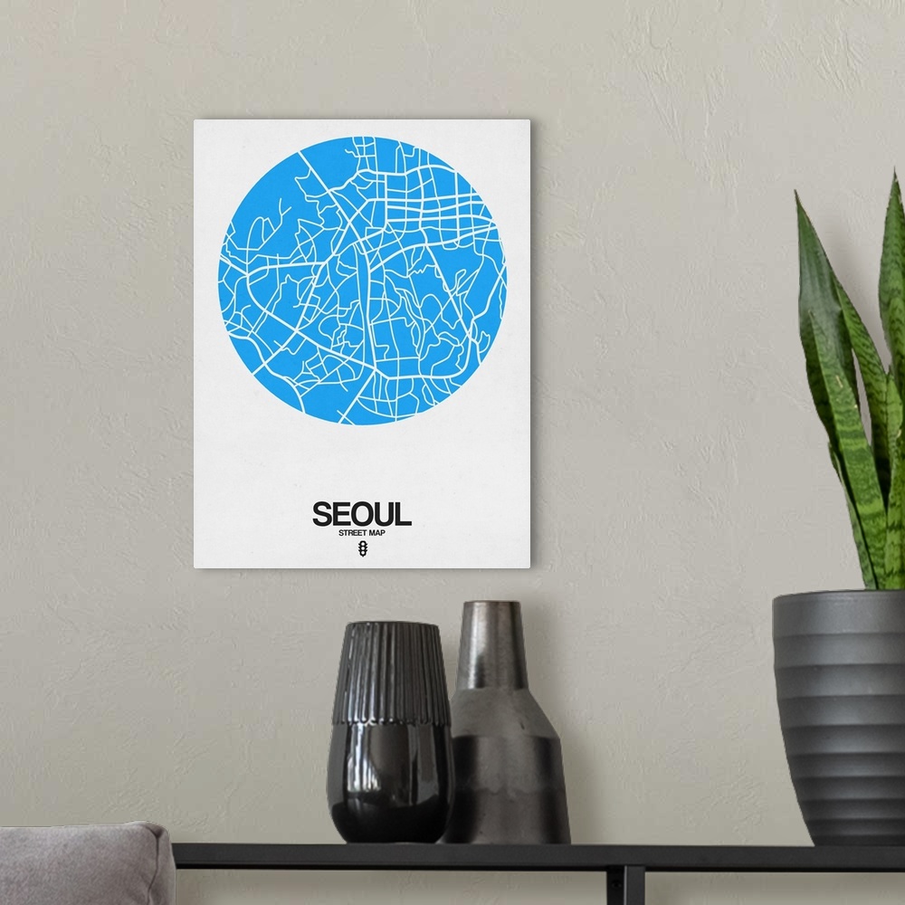 A modern room featuring Minimalist art map of the city streets of Seoul in white and blue.