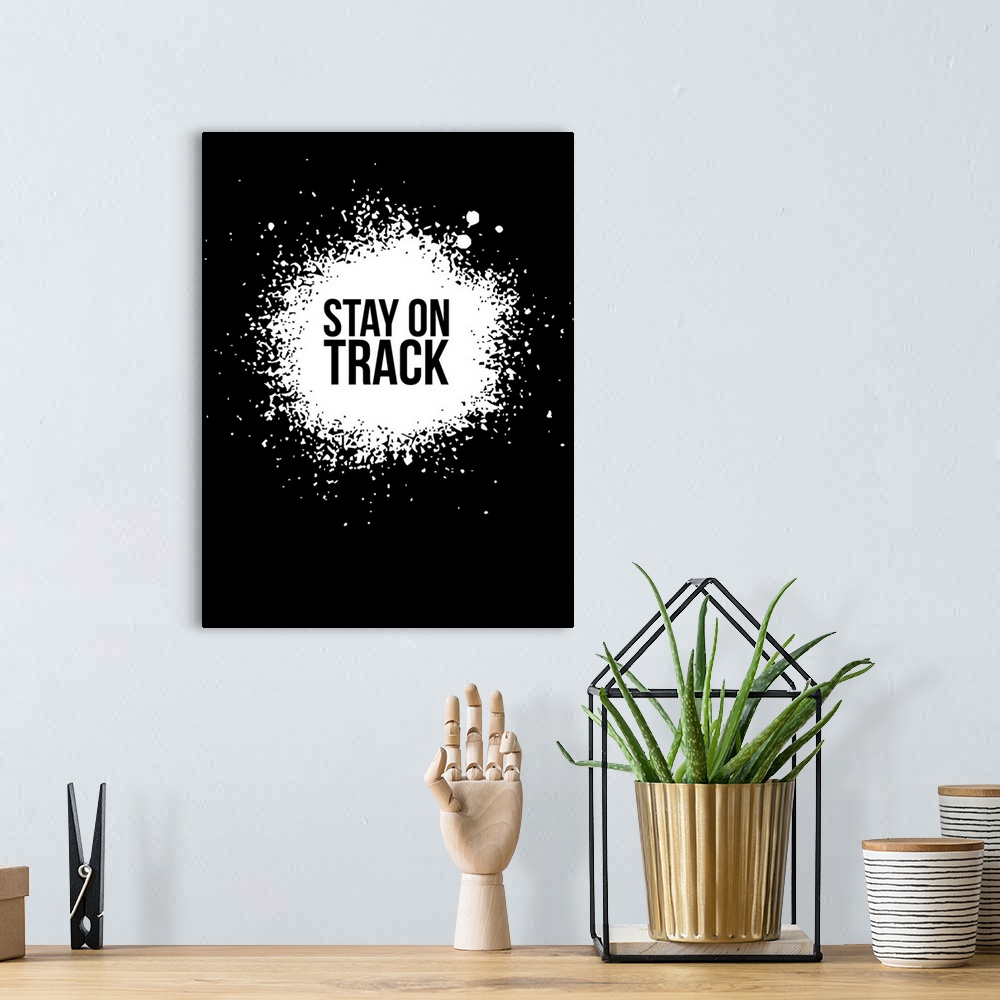 A bohemian room featuring Typography poster art using high contrast and paint splatter.