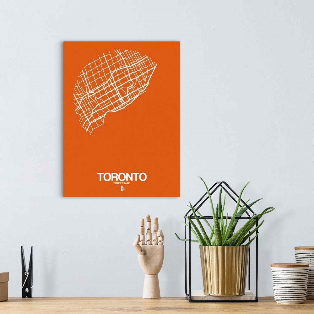 A bohemian room featuring Minimalist art map of the city streets of Toronto in orange and white.