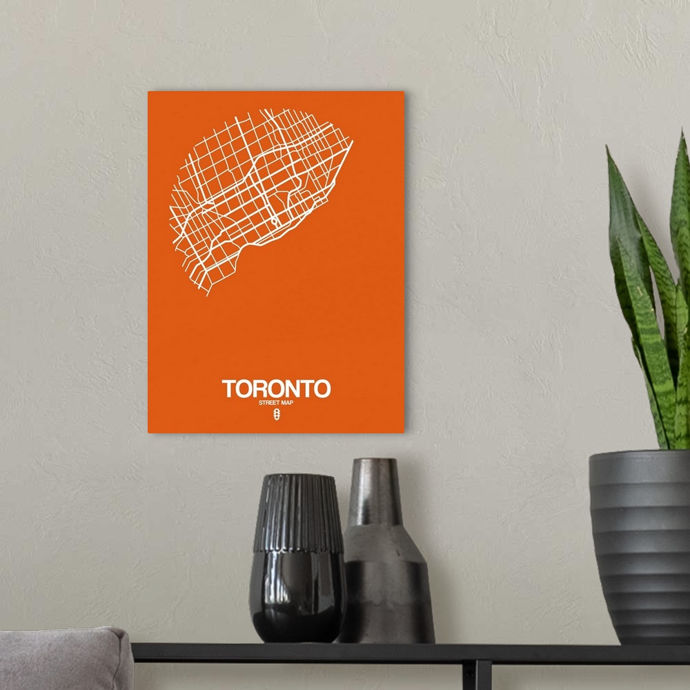 A modern room featuring Minimalist art map of the city streets of Toronto in orange and white.