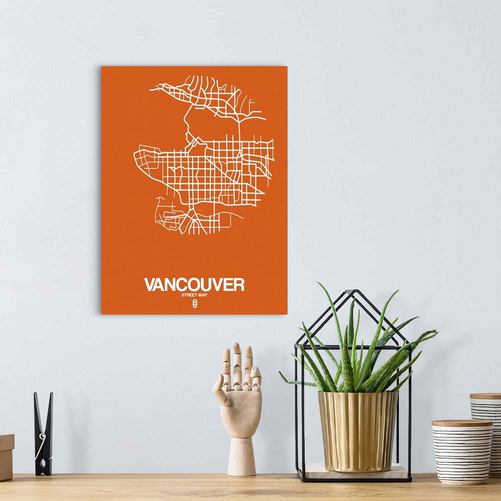 A bohemian room featuring Minimalist art map of the city streets of Vancouver in orange and white.