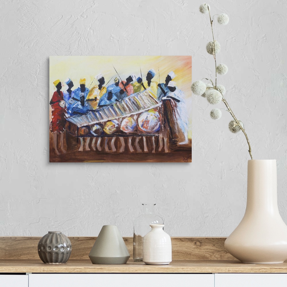A farmhouse room featuring Marking the rhythm for a xylophone melody, men stand behind beating drums. All is color and movem...