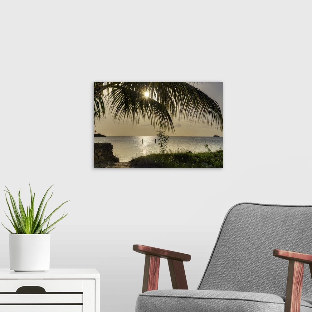 A modern room featuring Vibrant photograph of a beautiful sunset from the shore of Antigua.