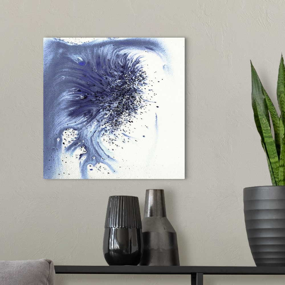 A modern room featuring Abstract artwork in blue splashes and drips and flowing paint.