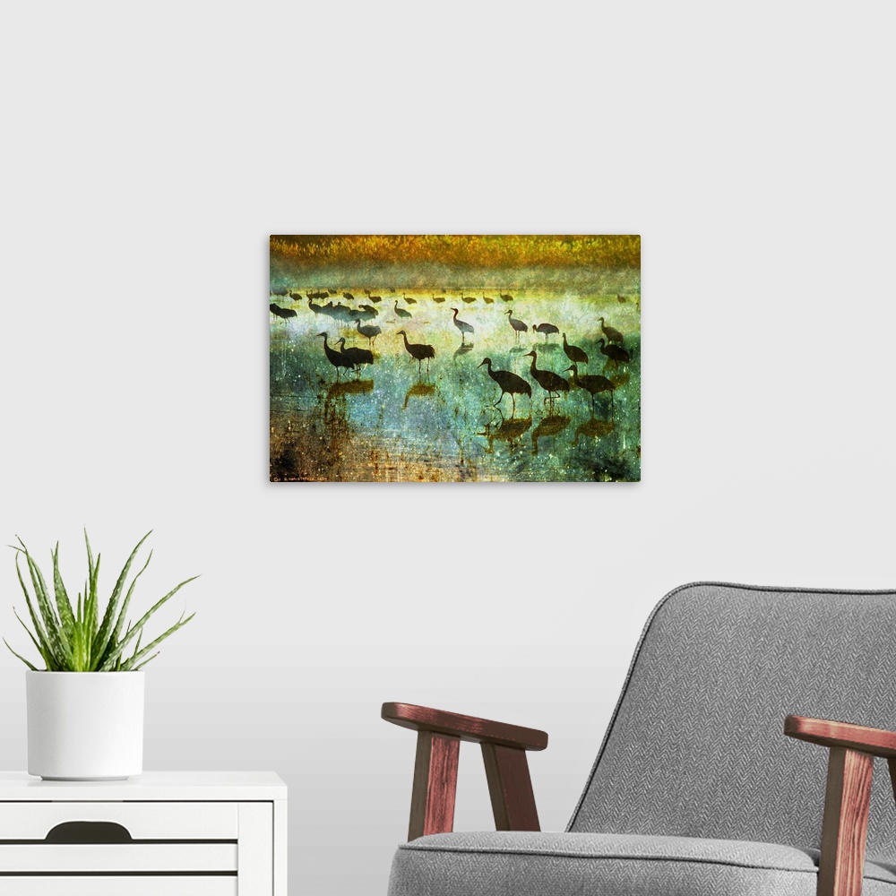 A modern room featuring Contemporary artwork of silhouetted cranes standing in water.