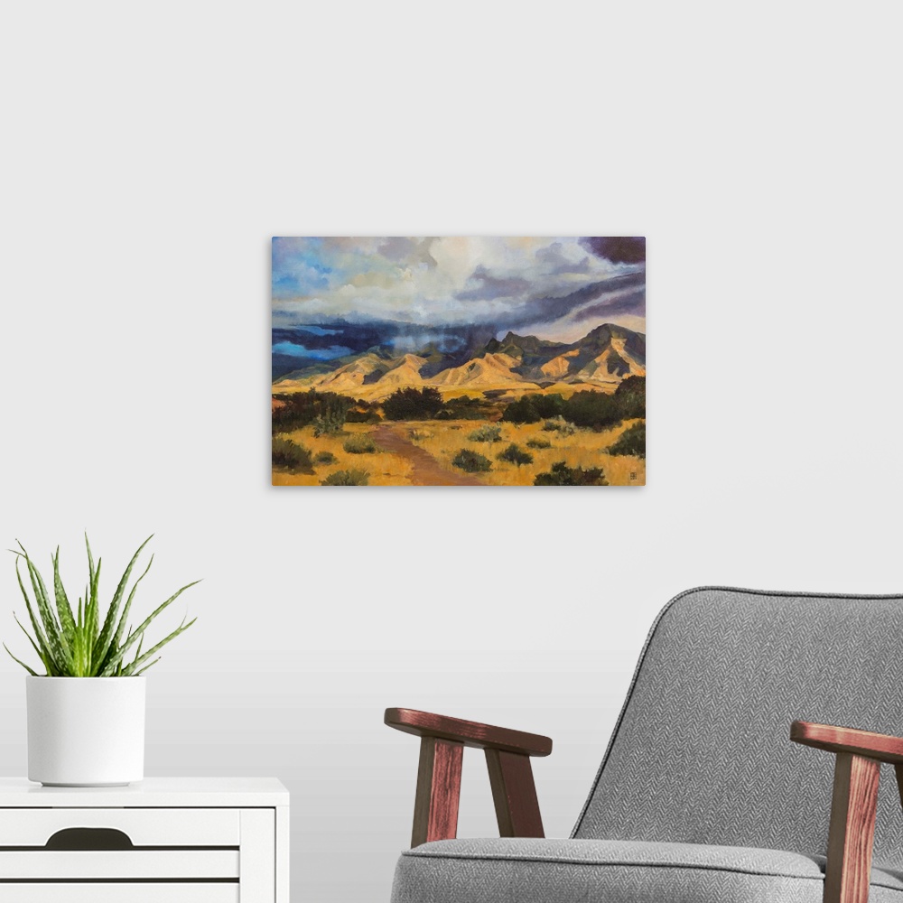 A modern room featuring Contemporary painting of an idyllic desert landscape with dark clouds hovering overhead.