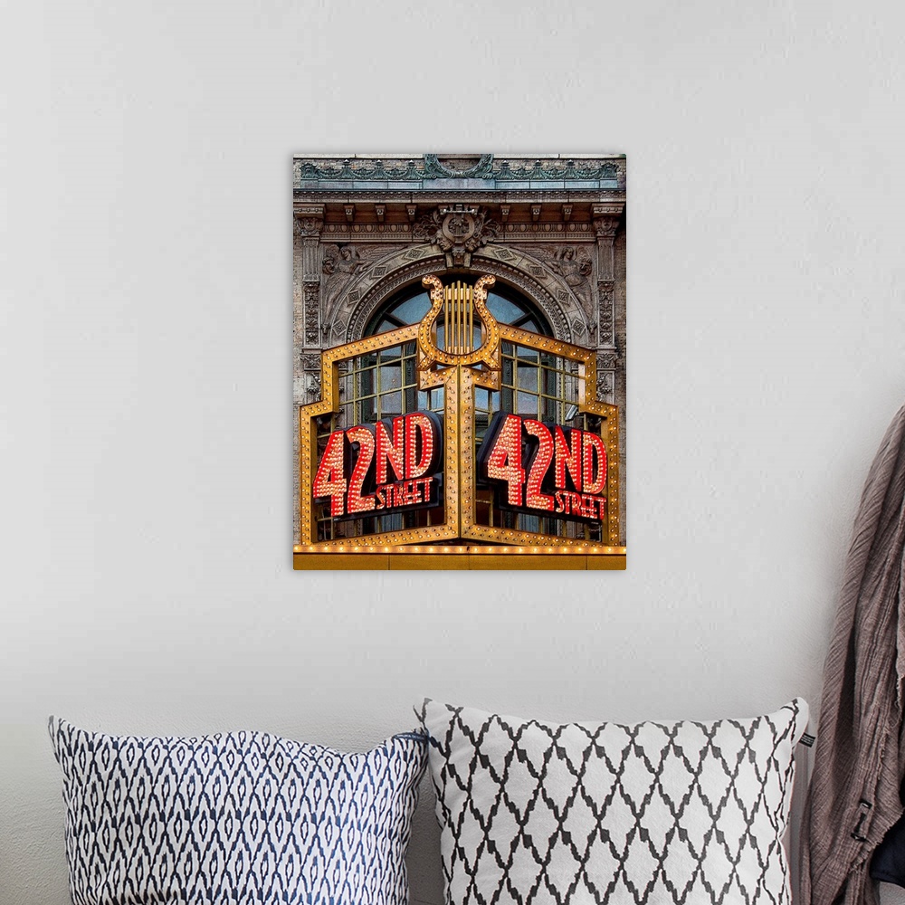 A bohemian room featuring Vibrant photograph of a lit up 42nd street sign on the facade of a building.