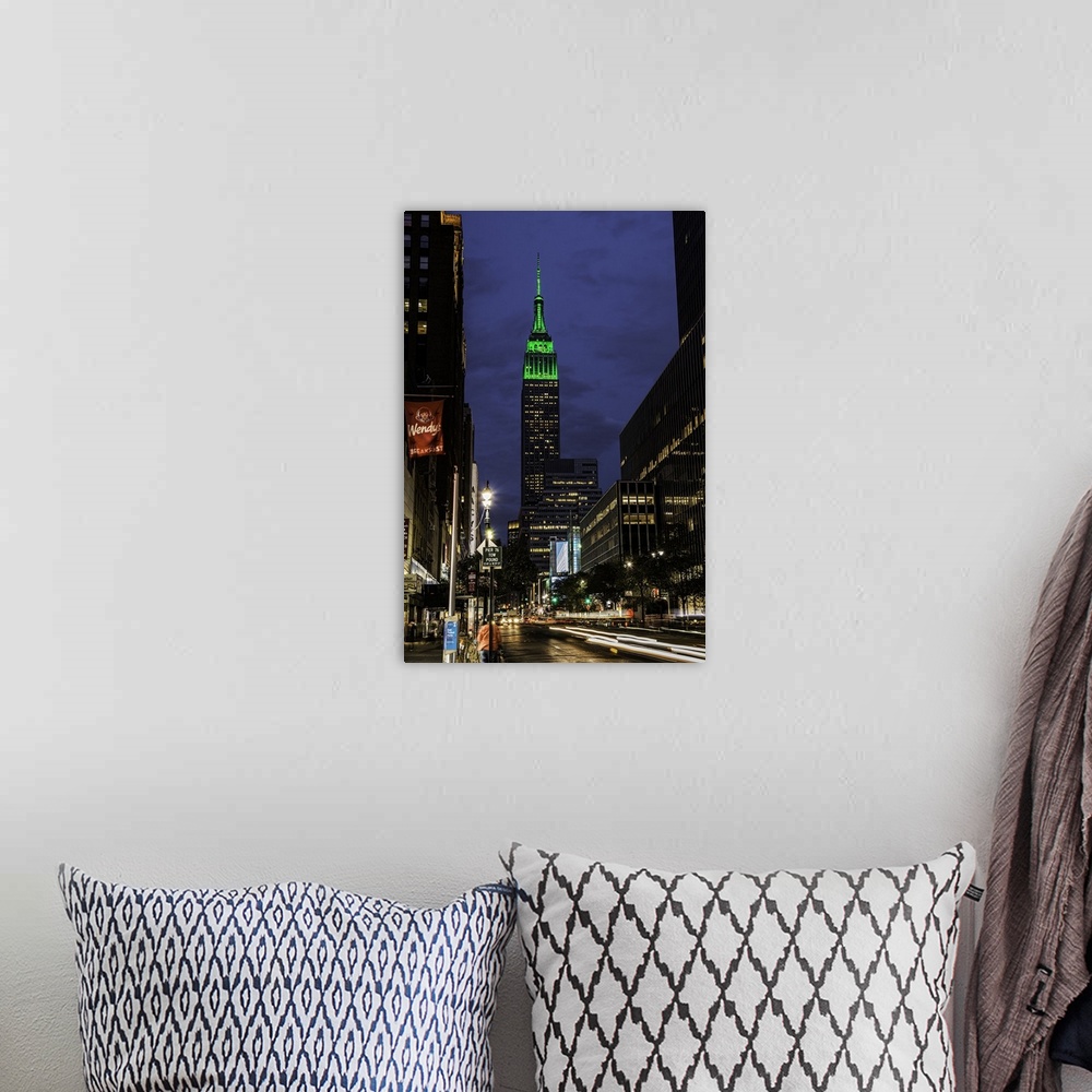 A bohemian room featuring A photograph of the Empire State Building with a green top at sunset.