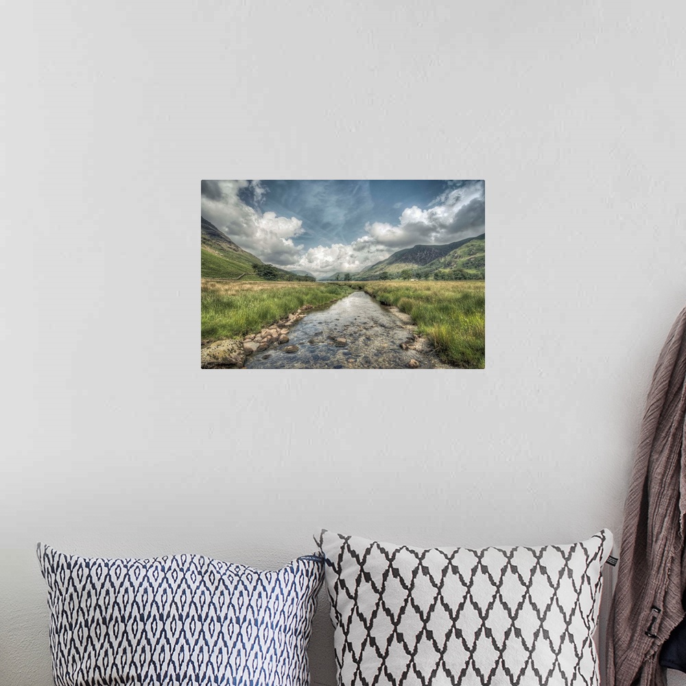 A bohemian room featuring HDR photograph of an idyllic countryside landscape looking toward a mountain range.