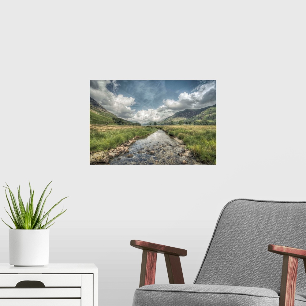 A modern room featuring HDR photograph of an idyllic countryside landscape looking toward a mountain range.