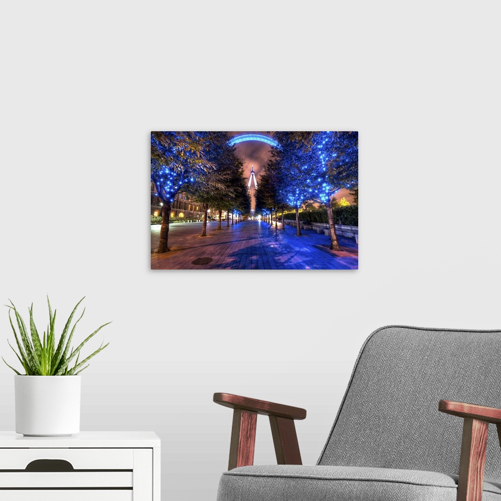 A modern room featuring HDR photograph of a view of the London Eye through a grove of lit up trees for Christmas.
