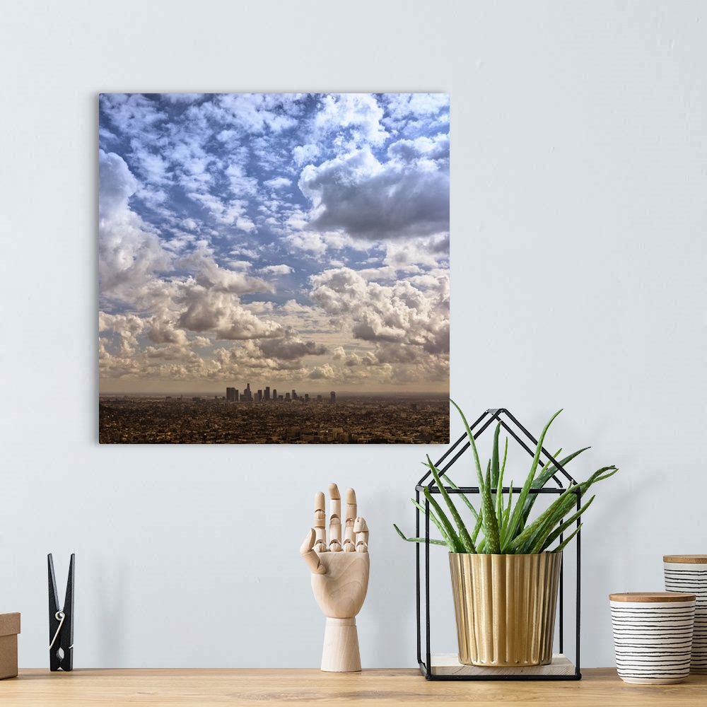 A bohemian room featuring Aerial photograph of the downtown LA area under a blanket of clouds.
