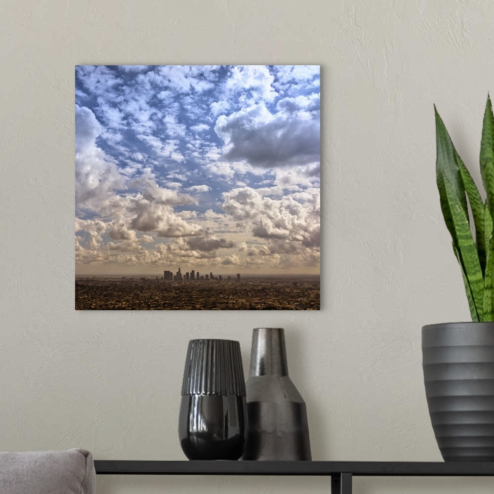 A modern room featuring Aerial photograph of the downtown LA area under a blanket of clouds.