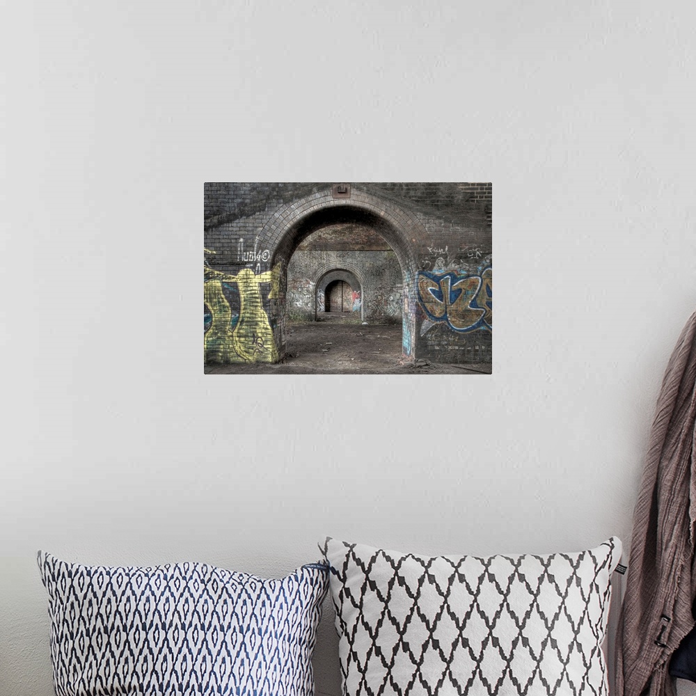 A bohemian room featuring HDR photograph of a tunnel with its walls filled with graffiti.