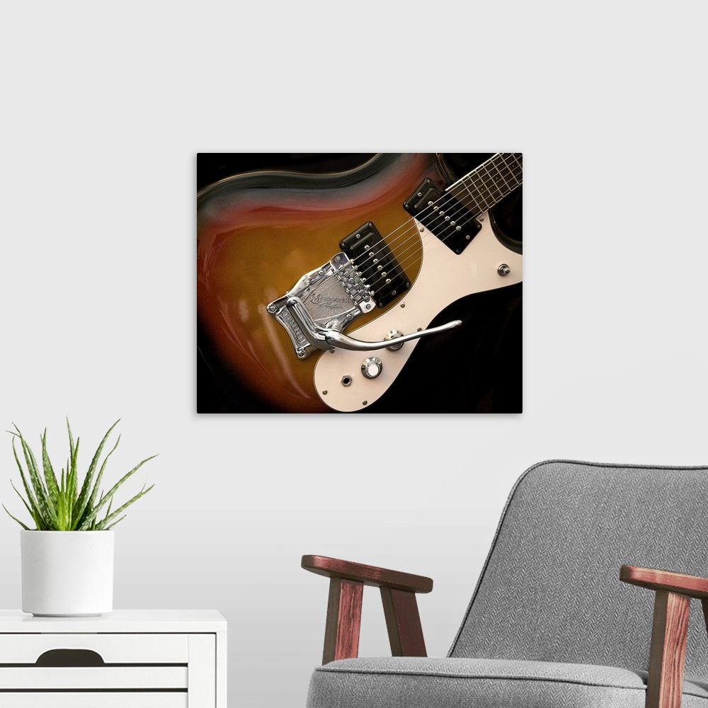 A modern room featuring Close-up photograph of an electric guitar.