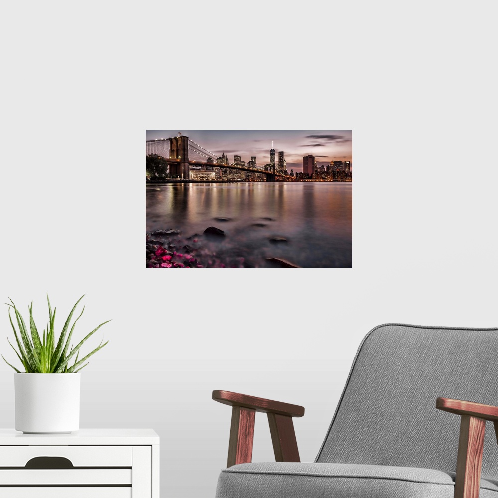 A modern room featuring A photograph of the NYC skyline at sunset.