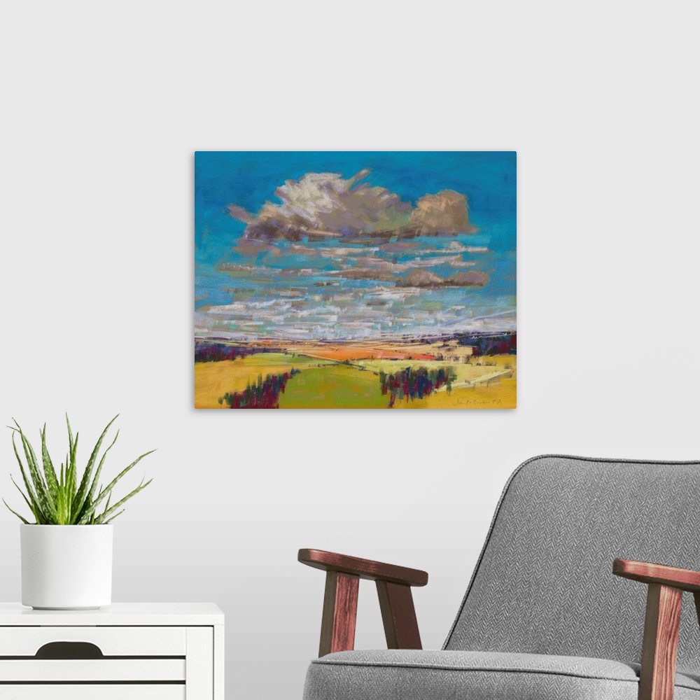 A modern room featuring Pastel landscape painting of English countryside with trees, fields and clouds.