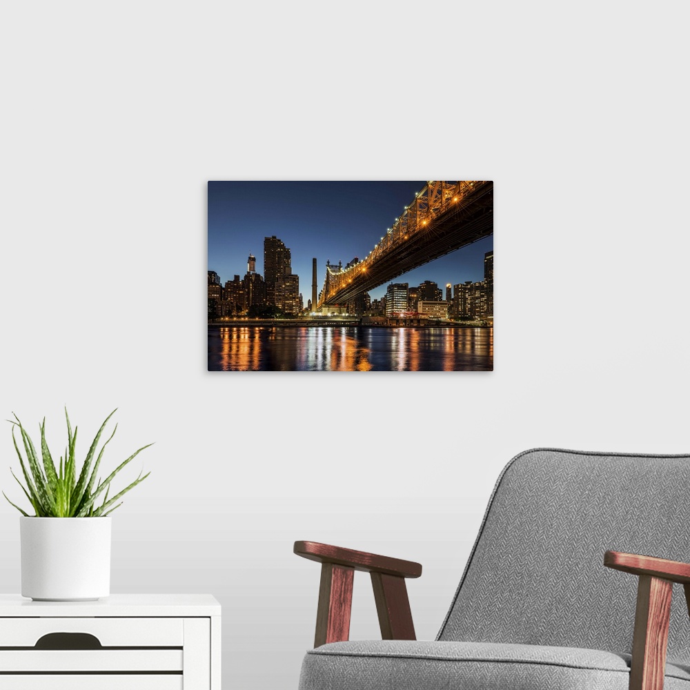A modern room featuring A photograph of the Queensboro bridge at night.