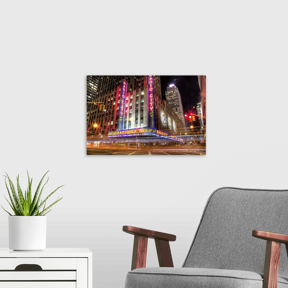 A modern room featuring HDR photograph of the Radio City building in New York city, with light trails from speeding cars.