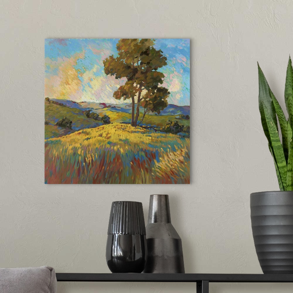 A modern room featuring Contemporary landscape painting of a tree standing over a field at sunset.
