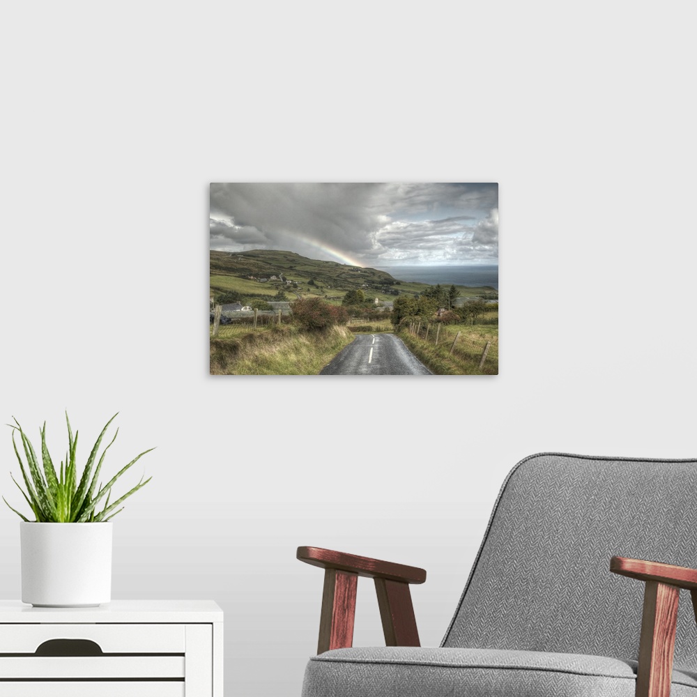 A modern room featuring A photograph looking down the road of a countryside landscape in Northern Ireland.