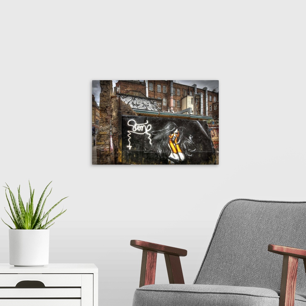 A modern room featuring Fine art photograph of a graffiti on the facade of a city building.