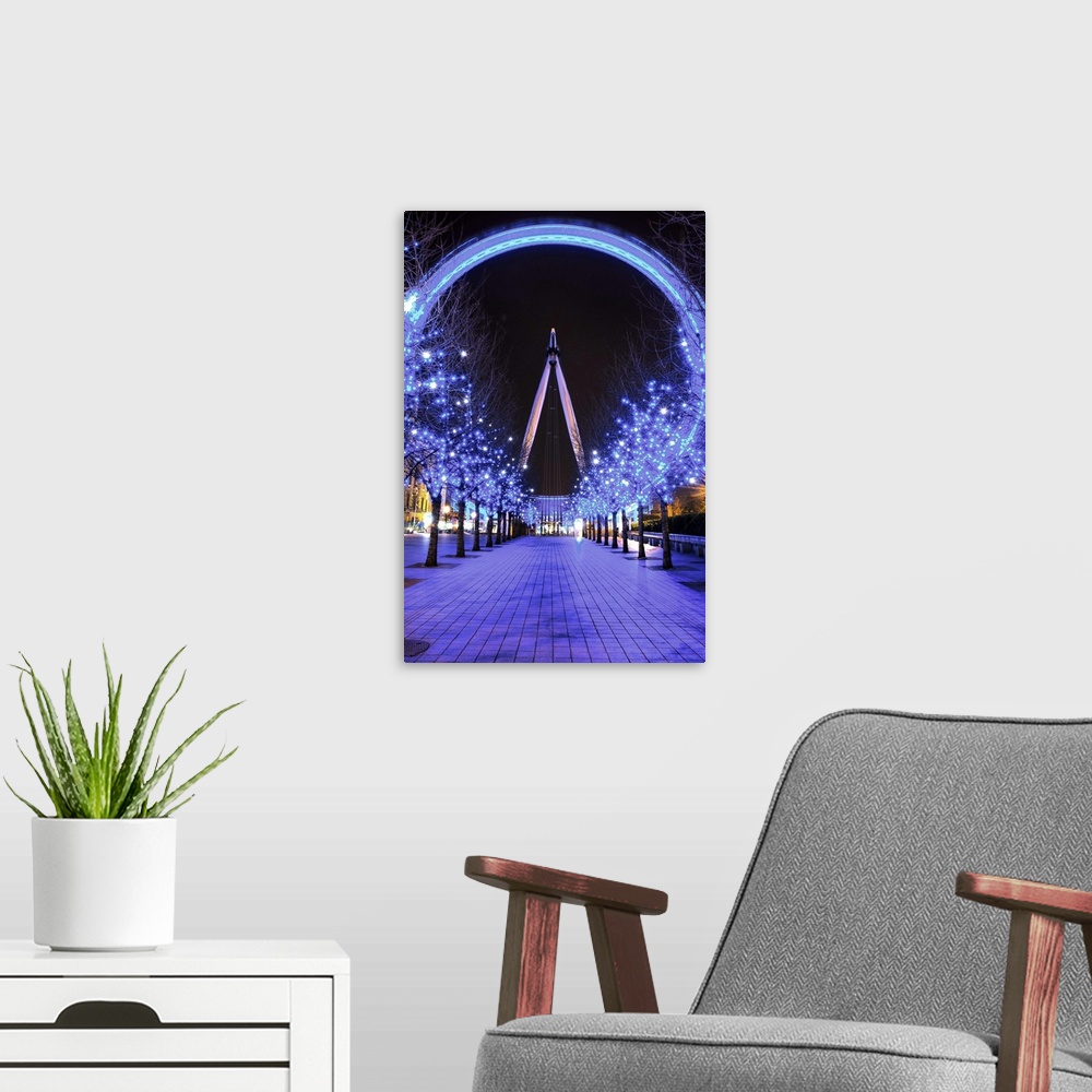 A modern room featuring A photograph of the London Eye from a long aisle of blue lit up trees for Christmas.