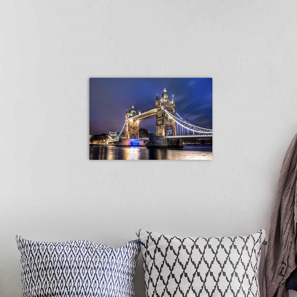 A bohemian room featuring A photograph of the Tower Bridge spanning the river Thames in London, England.