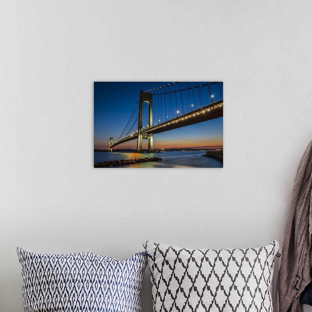 A bohemian room featuring A photograph of the Verrazano-Narrows Bridge at twilight.