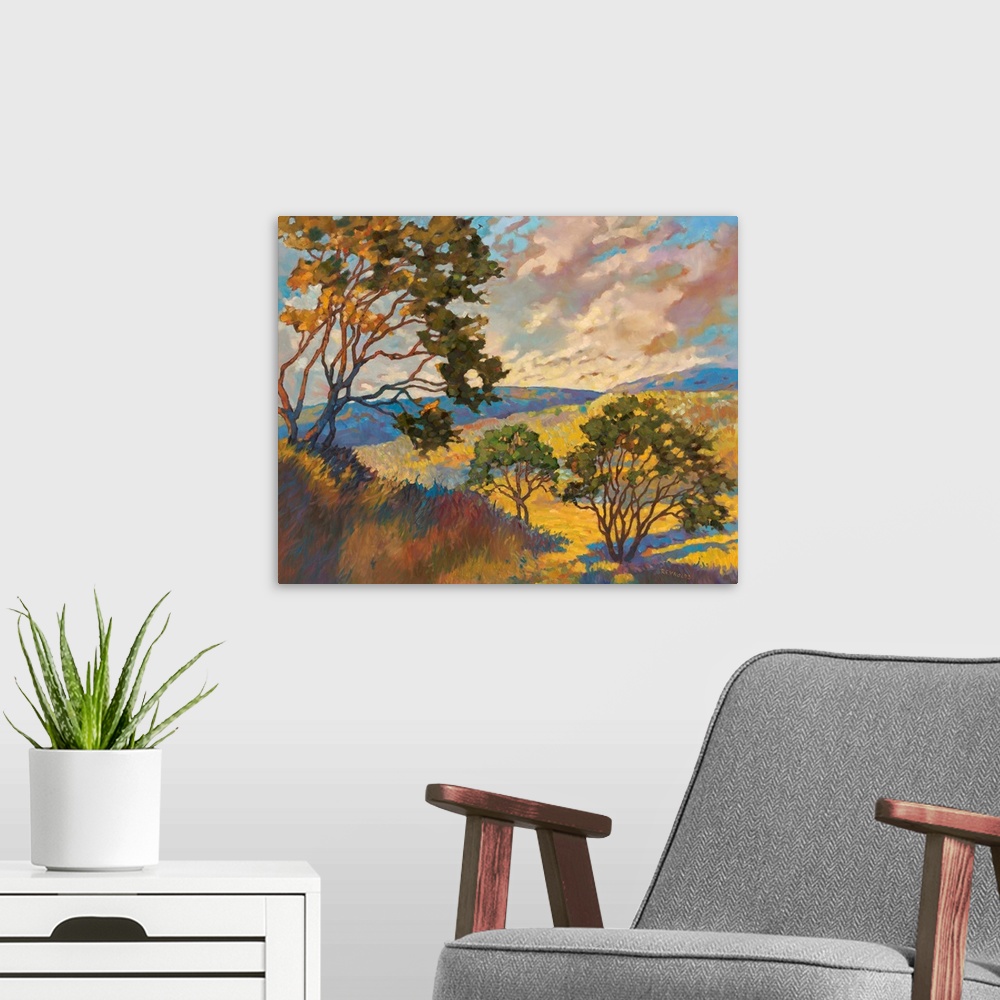 A modern room featuring Contemporary landscape painting of trees in rolling yellow fields at sunset.