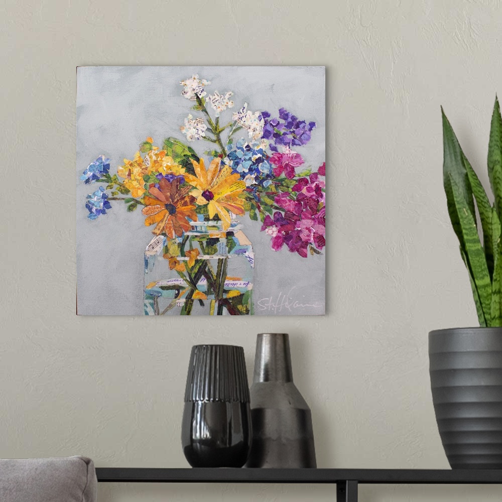 A modern room featuring Mixed media collage of wildflowers of yellow, pink, purple, and white in a clear glass jar.