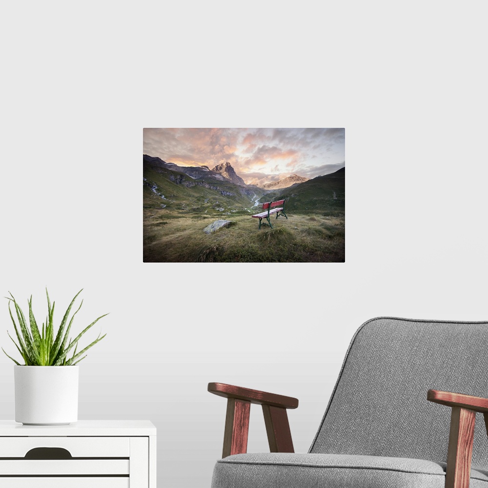 A modern room featuring Dramatic clouds over a mountain valley with a bench.
