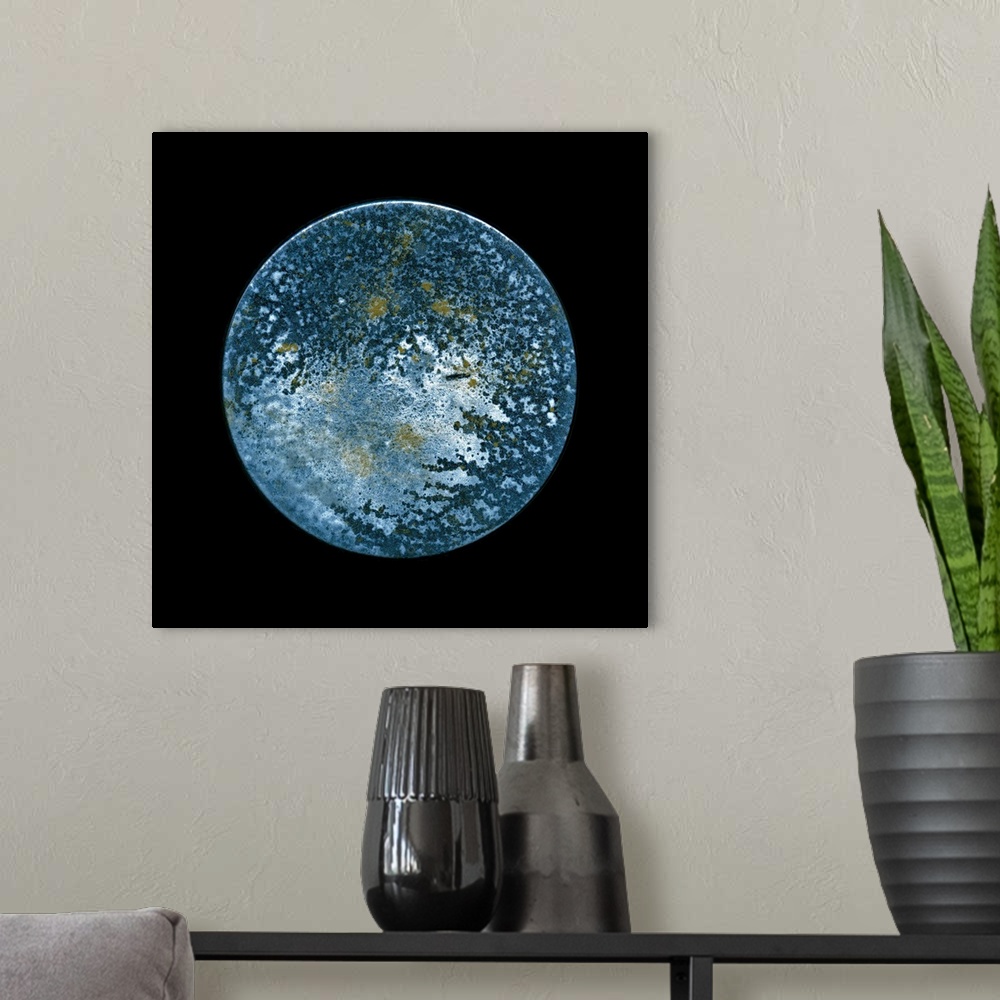 A modern room featuring A minimalist circular surreal moon on a black background in textured blues and silvery shades.