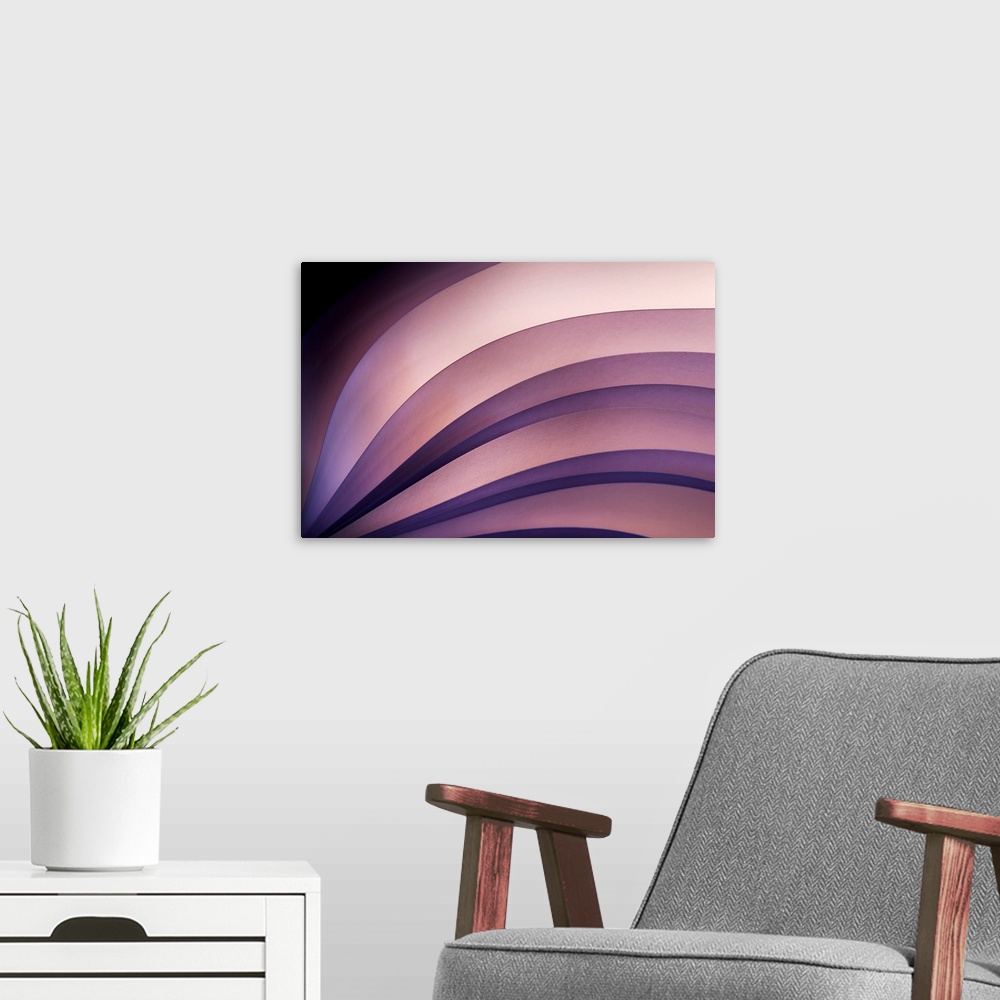 A modern room featuring Waves and curves of different shaded purples are used in this abstract piece.