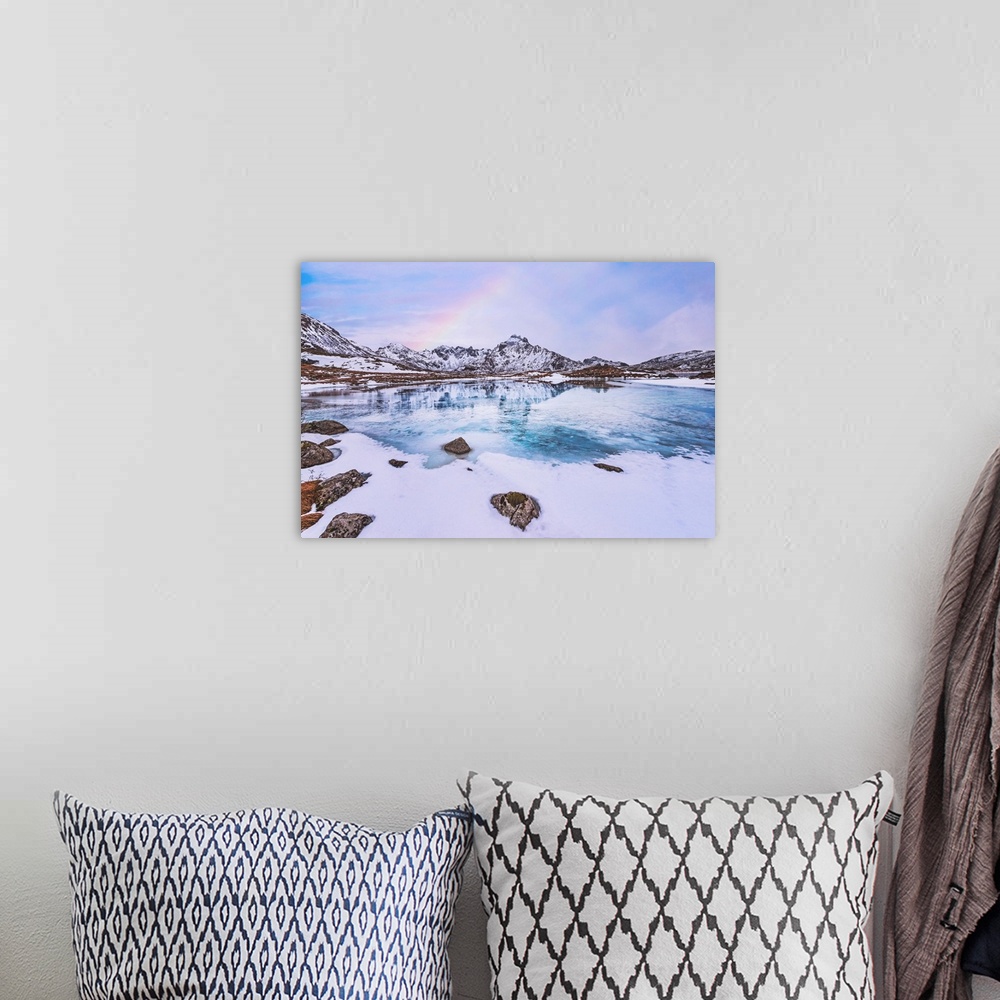 A bohemian room featuring Frozen lake in the mountains with a rainbow