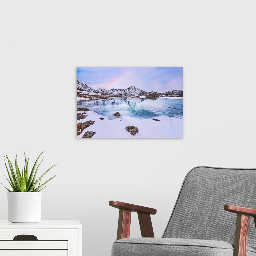 A modern room featuring Frozen lake in the mountains with a rainbow
