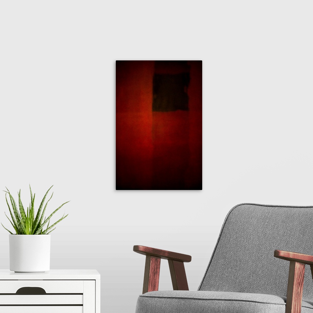 A modern room featuring Geometric abstract artwork that consists of deep reds and subtle polygonal shapes.